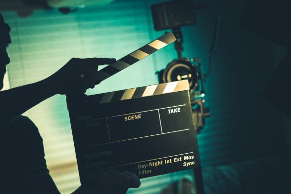 Person Holding a Clapperboard Symbolizing Starting Over With a Greener Footprint With Geothernal Energy