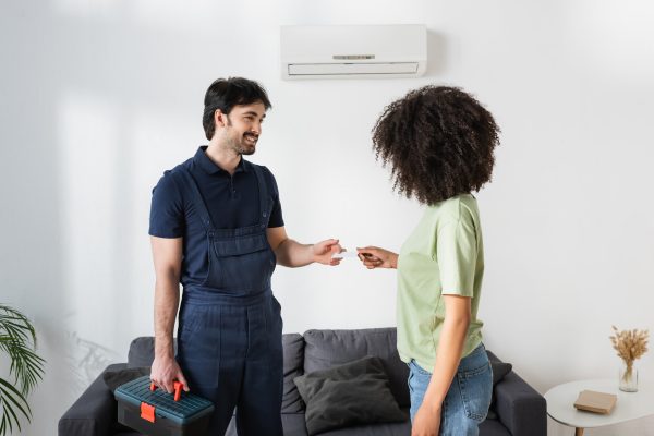 HVAC Technician with client after performing Winter Service on Geothermal Heat Pumps and AC Furnace Systems HVAC Technician with client after performing Winter Service on Geothermal Heat Pumps and AC Furnace Systems
