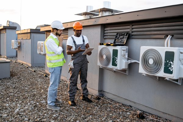 HVAC Technicians reviewing System Before Winter Service on Geothermal Heat Pumps and AC Furnace Systems