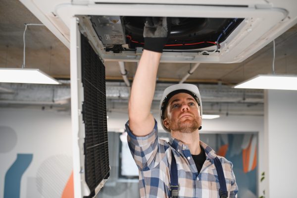 Hvac technician repairing Commercial Residential HVAC Services Conventional And Geothermal Systems
