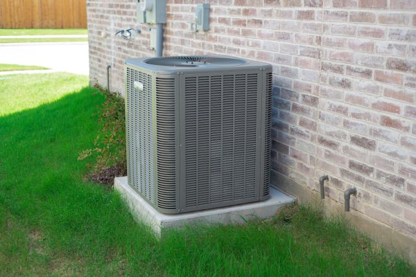 Residential outdoor air conditioning condenser unit next to home in Metro Atlanta, highlighting importance of spring HVAC maintenance to prevent summer breakdowns