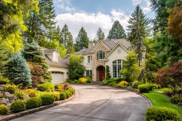 Luxury residential home in Buckhead, Atlanta surrounded by landscaped greenery, representing the need for spring HVAC service, air conditioning maintenance, and reliable home comfort before rising summer temperatures.