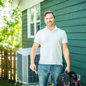 HVAC technician standing near an outdoor heat pump, ready to diagnose cooling and air conditioning problems.