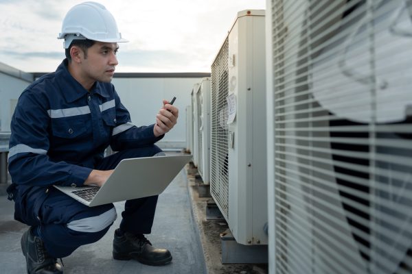 Atlanta Technician diagnosing a commercial rooftop heat pump to identify cooling and performance issues