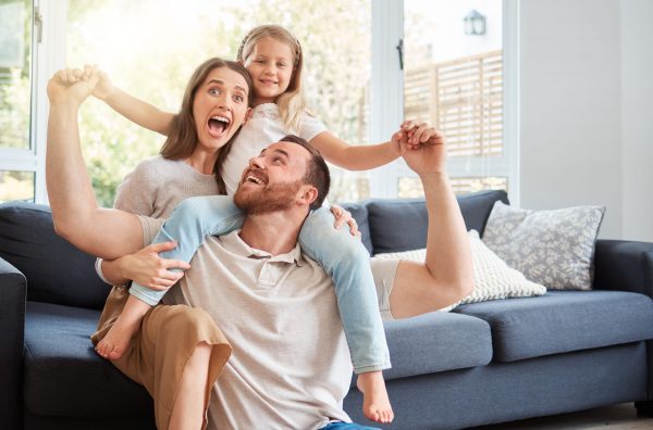 Happy family enjoying balanced indoor humidity and cool comfort after professional Atlanta HVAC service from Ecomech
